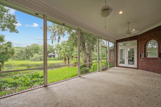 unfurnished sunroom featuring plenty of natural light and ceiling fan