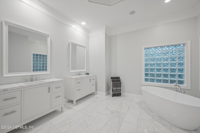 bathroom with crown molding, vanity, and a bathing tub