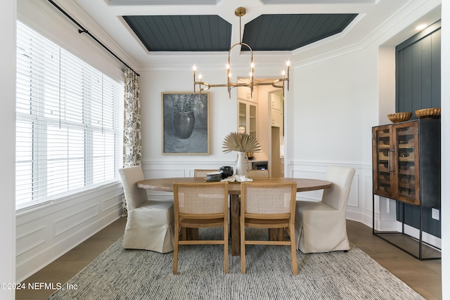 dining space featuring crown molding, a chandelier, and hardwood / wood-style floors