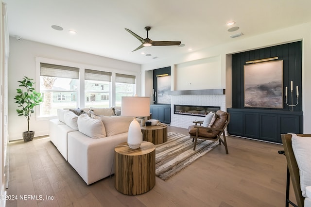 living room featuring ceiling fan and light hardwood / wood-style floors