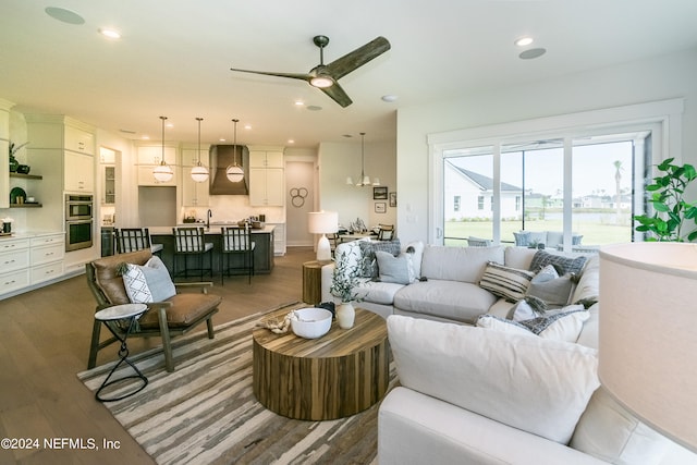 living room featuring dark hardwood / wood-style floors and ceiling fan