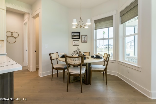 dining room with a notable chandelier and dark hardwood / wood-style floors