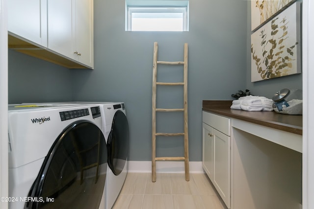 washroom featuring independent washer and dryer and cabinets