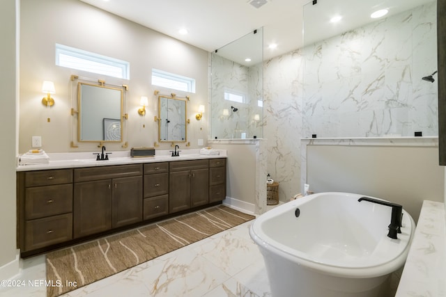 bathroom with vanity and shower with separate bathtub