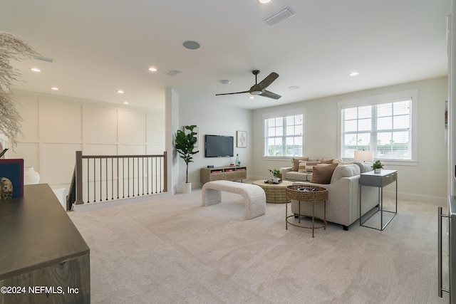 living room with light carpet and ceiling fan