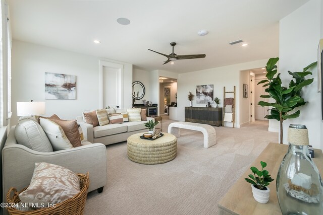 carpeted living room featuring ceiling fan