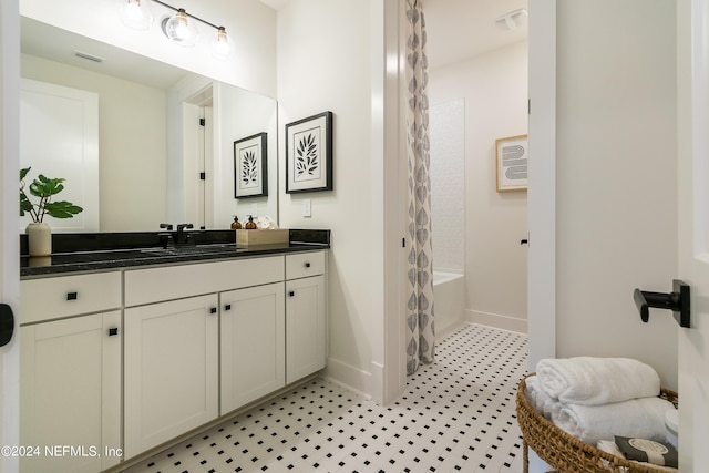 bathroom with vanity and shower / bath combo with shower curtain