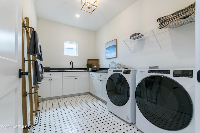 laundry room with cabinets, washing machine and dryer, and sink