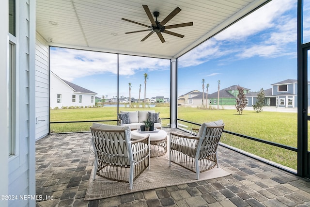 sunroom / solarium featuring ceiling fan