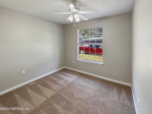 unfurnished room featuring light carpet and ceiling fan