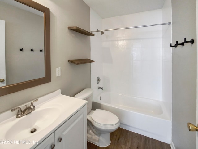 full bathroom featuring hardwood / wood-style floors, large vanity, bathtub / shower combination, and toilet