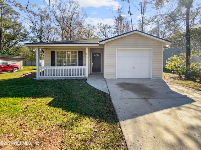 ranch-style house featuring covered porch, a front yard, and a garage