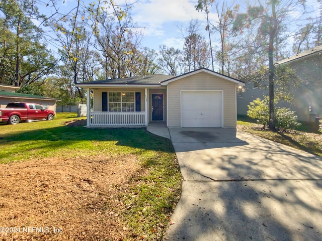 ranch-style home with covered porch, a front yard, and a garage