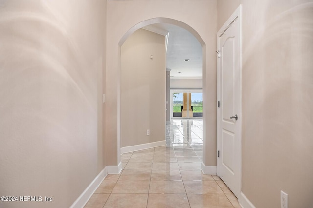 13846 Atlantic Blvd Unit 902, Jacksonville, FL 32225 - hallway with light tile patterned flooring, arched walkways, and baseboards