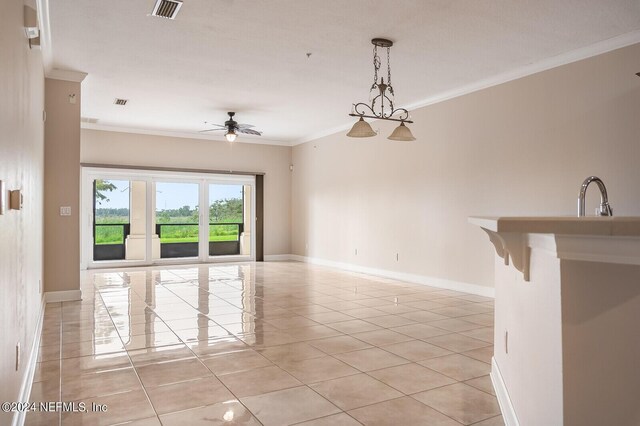 tiled spare room with crown molding, ceiling fan, and sink