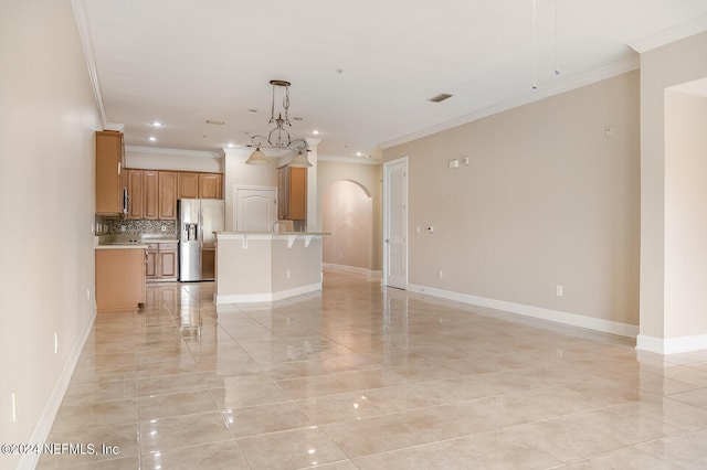 13846 Atlantic Blvd Unit 902, Jacksonville, FL 32225 - unfurnished living room featuring baseboards, crown molding, and arched walkways