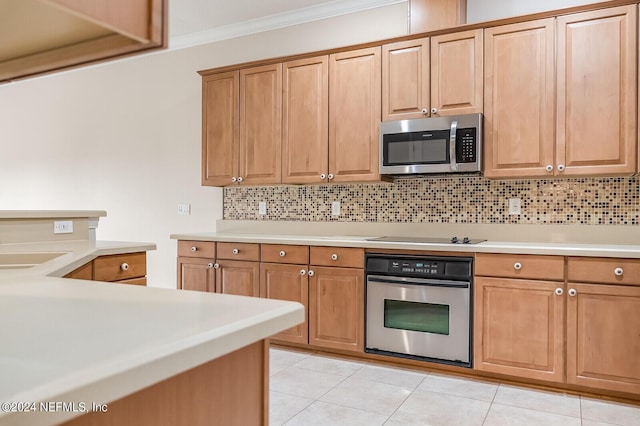 13846 Atlantic Blvd Unit 902, Jacksonville, FL 32225 - kitchen with decorative backsplash, light tile patterned flooring, light countertops, crown molding, and appliances with stainless steel finishes