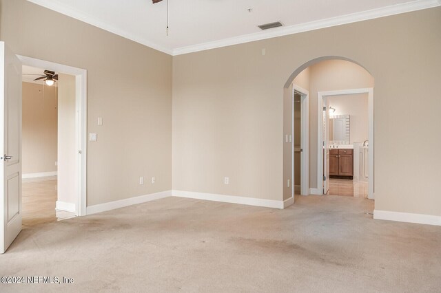 unfurnished room featuring ornamental molding, light colored carpet, and ceiling fan