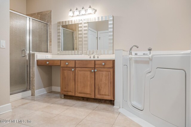 bathroom with washer / clothes dryer, a shower with shower door, vanity, and tile patterned floors