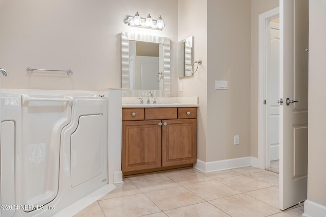 13846 Atlantic Blvd Unit 902, Jacksonville, FL 32225 - bathroom featuring vanity, baseboards, tile patterned floors, and washer / dryer