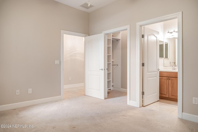13846 Atlantic Blvd Unit 902, Jacksonville, FL 32225 - unfurnished bedroom with a walk in closet, light colored carpet, baseboards, visible vents, and a closet
