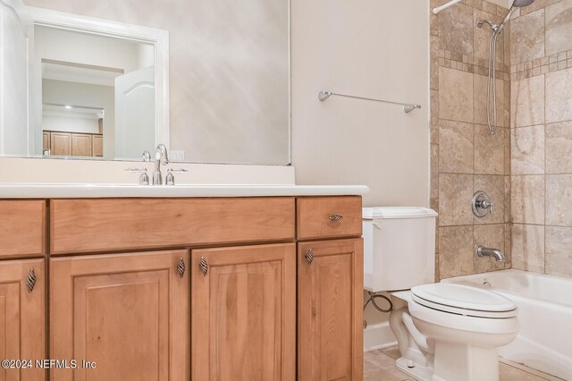 full bathroom with vanity, toilet, tiled shower / bath combo, and tile patterned floors