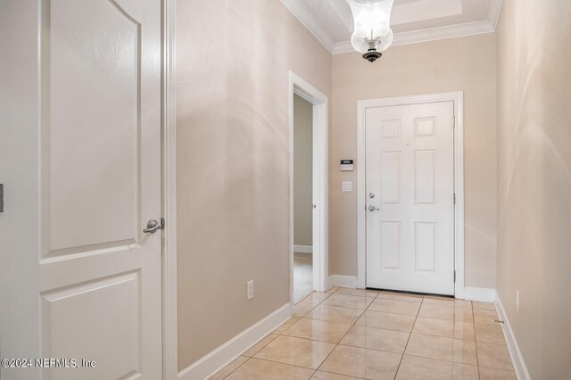 tiled entryway featuring ornamental molding