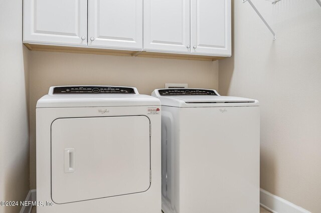 laundry room with cabinets and washing machine and dryer