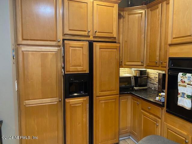 kitchen featuring dark stone countertops and oven