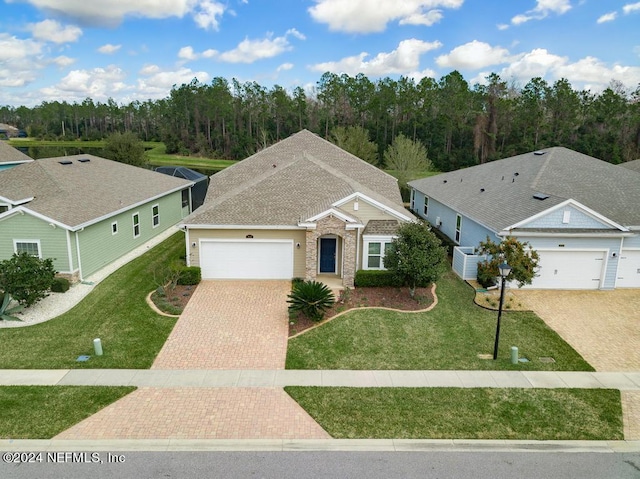 view of front of house with a front yard, a garage, and central air condition unit