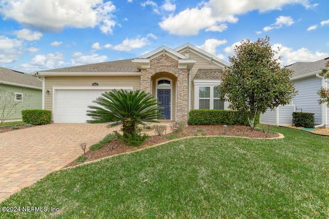 view of front of property with a front yard and a garage