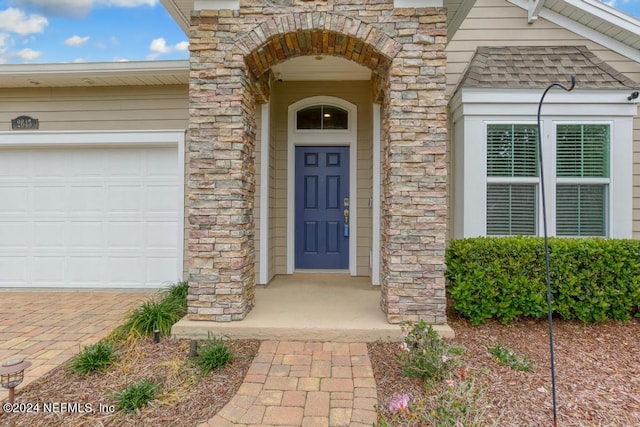 doorway to property with a garage