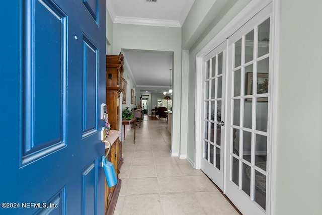 tiled foyer featuring crown molding and french doors