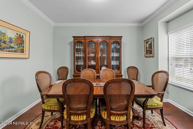 dining room with crown molding and dark hardwood / wood-style floors