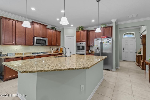 kitchen featuring an island with sink, pendant lighting, stainless steel appliances, light tile floors, and sink