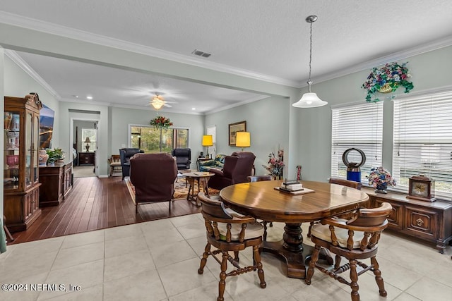 dining room with light tile flooring and ornamental molding