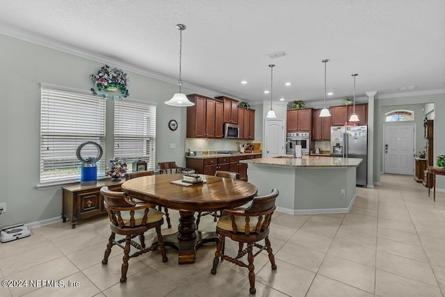 dining room with crown molding, sink, and light tile floors