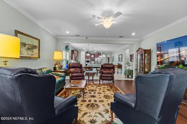 living room featuring ceiling fan, dark wood-type flooring, and ornamental molding