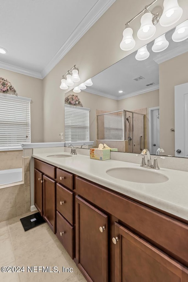 bathroom with double sink, tile flooring, independent shower and bath, and vanity with extensive cabinet space