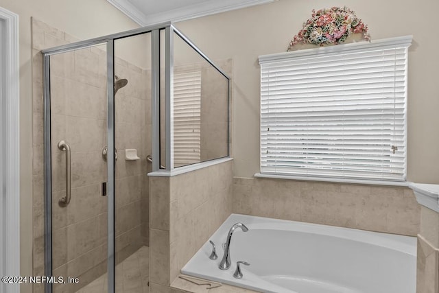 bathroom with crown molding, plenty of natural light, and separate shower and tub