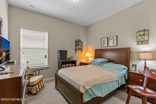 bedroom with light colored carpet