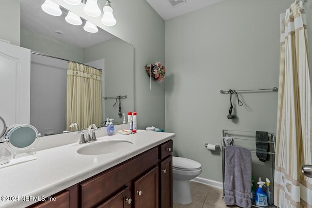 bathroom with vanity, tile flooring, and toilet