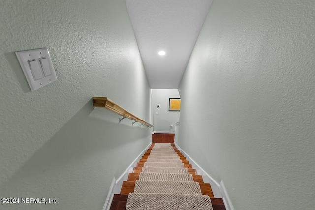 staircase with dark hardwood / wood-style flooring