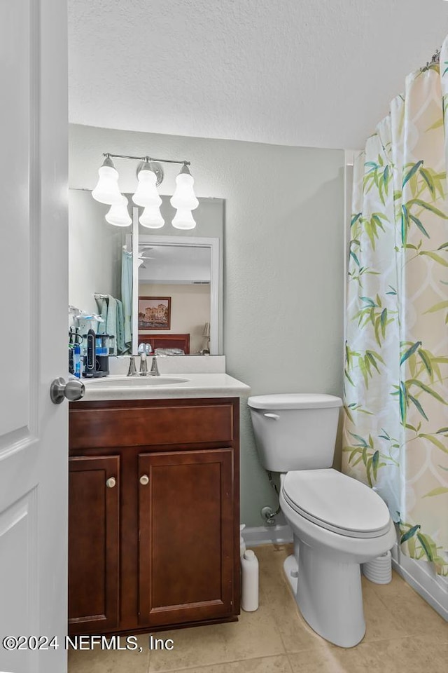 bathroom featuring tile floors, toilet, and vanity