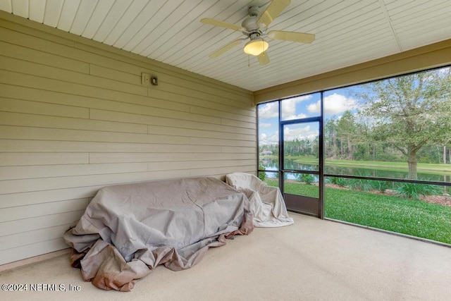 sunroom / solarium with a water view and ceiling fan