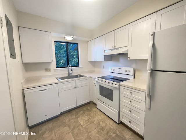 kitchen featuring white appliances, white cabinetry, sink, and light tile flooring