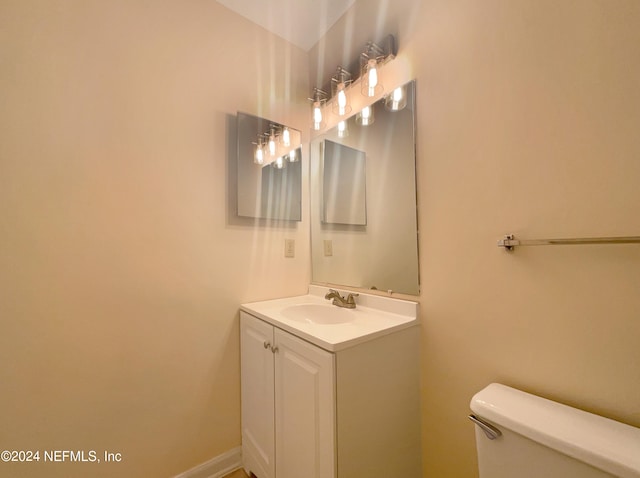 bathroom featuring toilet and large vanity