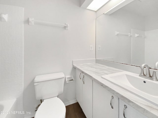 full bathroom with toilet, vanity with extensive cabinet space, hardwood / wood-style floors, and bathtub / shower combination