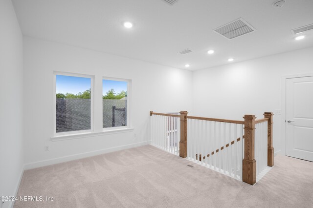 spare room with light colored carpet