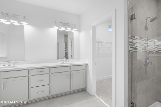 bathroom featuring tile patterned flooring, vanity, and an enclosed shower